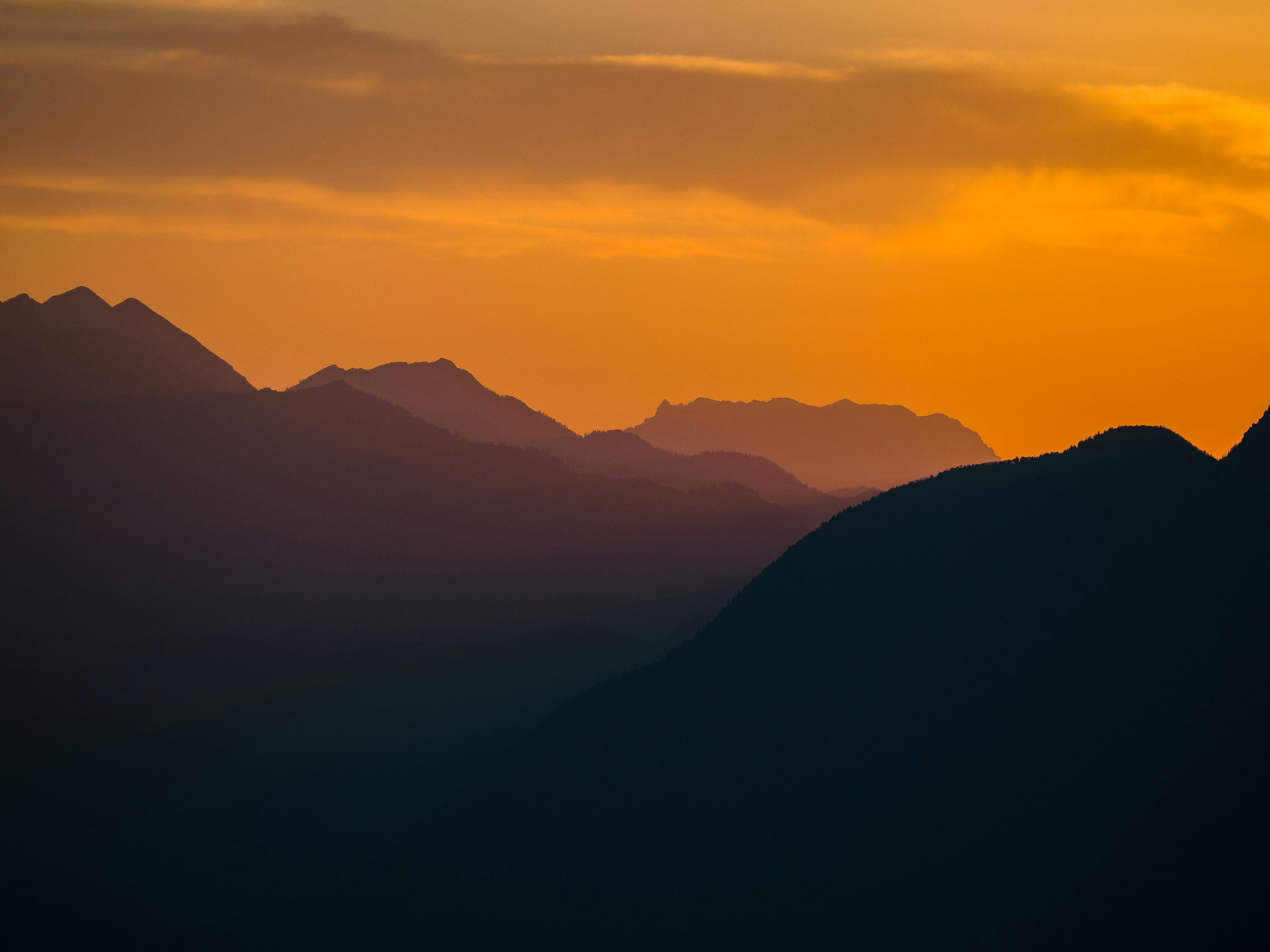 silhouette of mountains during sunset